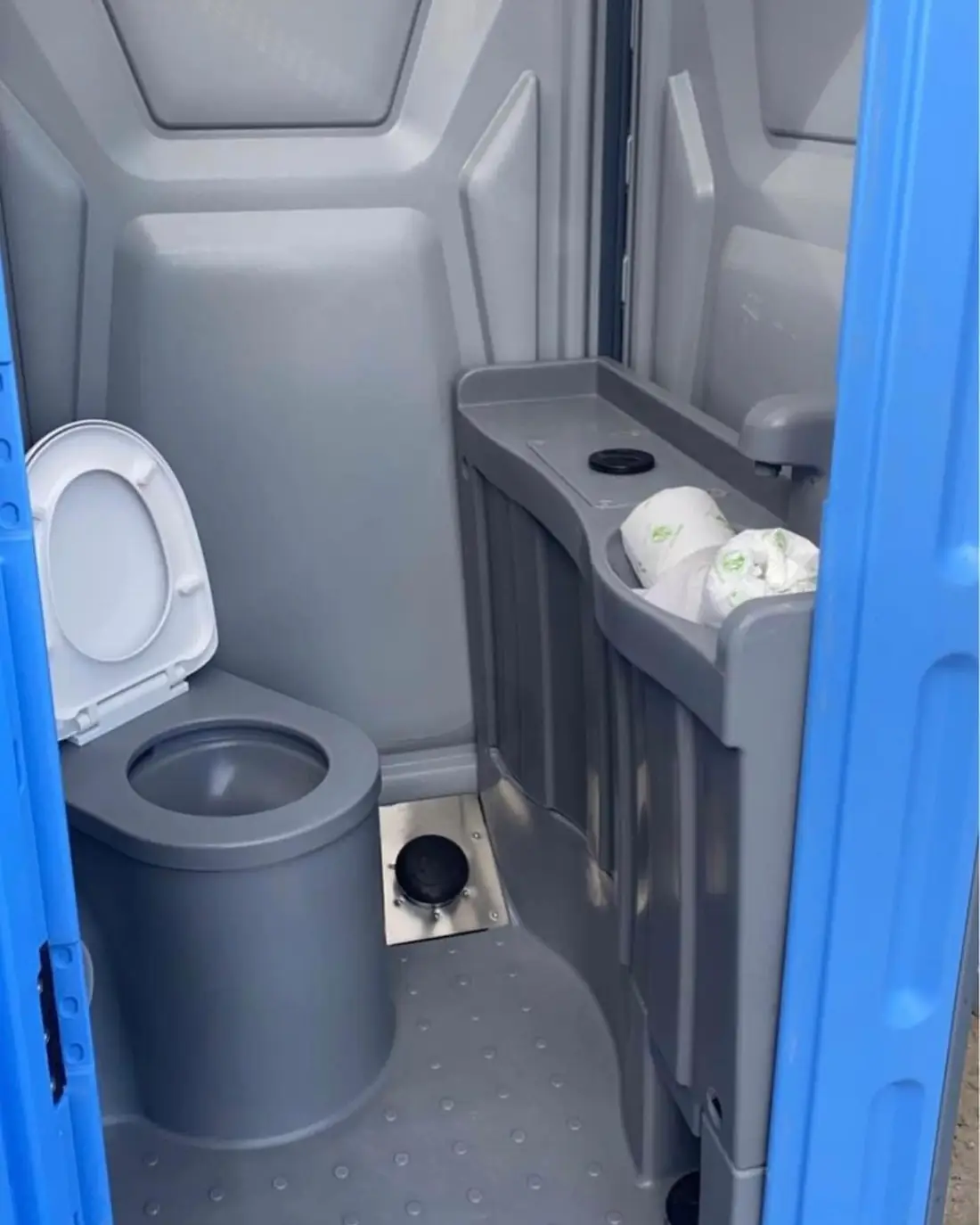 Portable toilet interior with a foot-pump hand sink